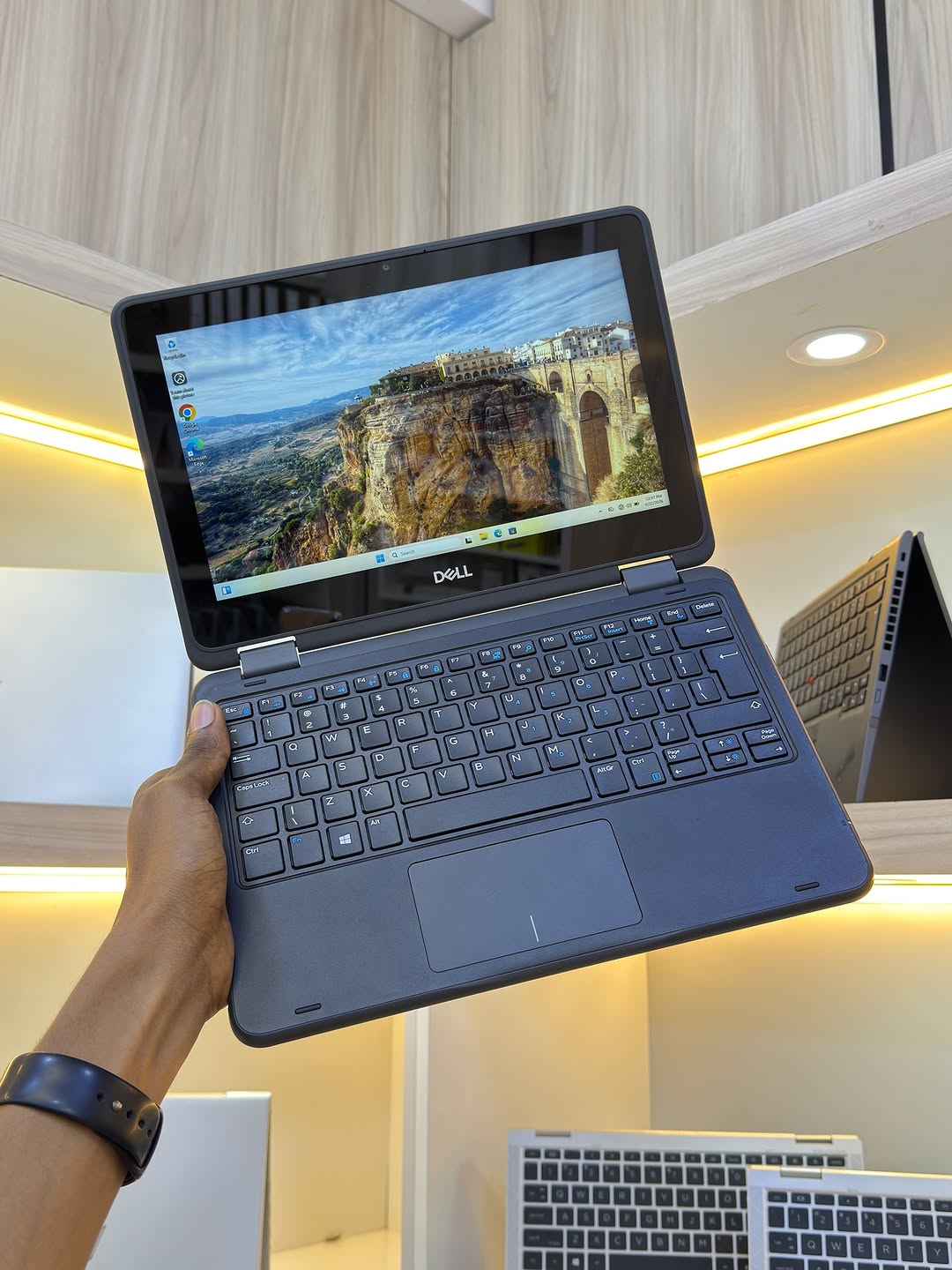Dell Latitude 3190 held up showing screen